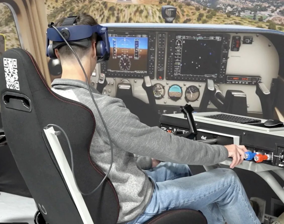 A student wearing a VR headset operates a True Course Simulations cockpit